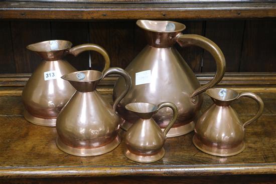 A graduated set of five 19th century French copper jugs
